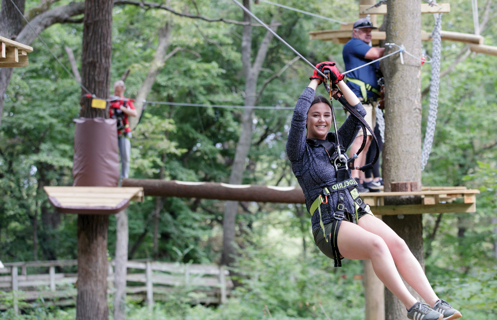 Woman riding a zip line at Fontenelle Forest Tree Rush.